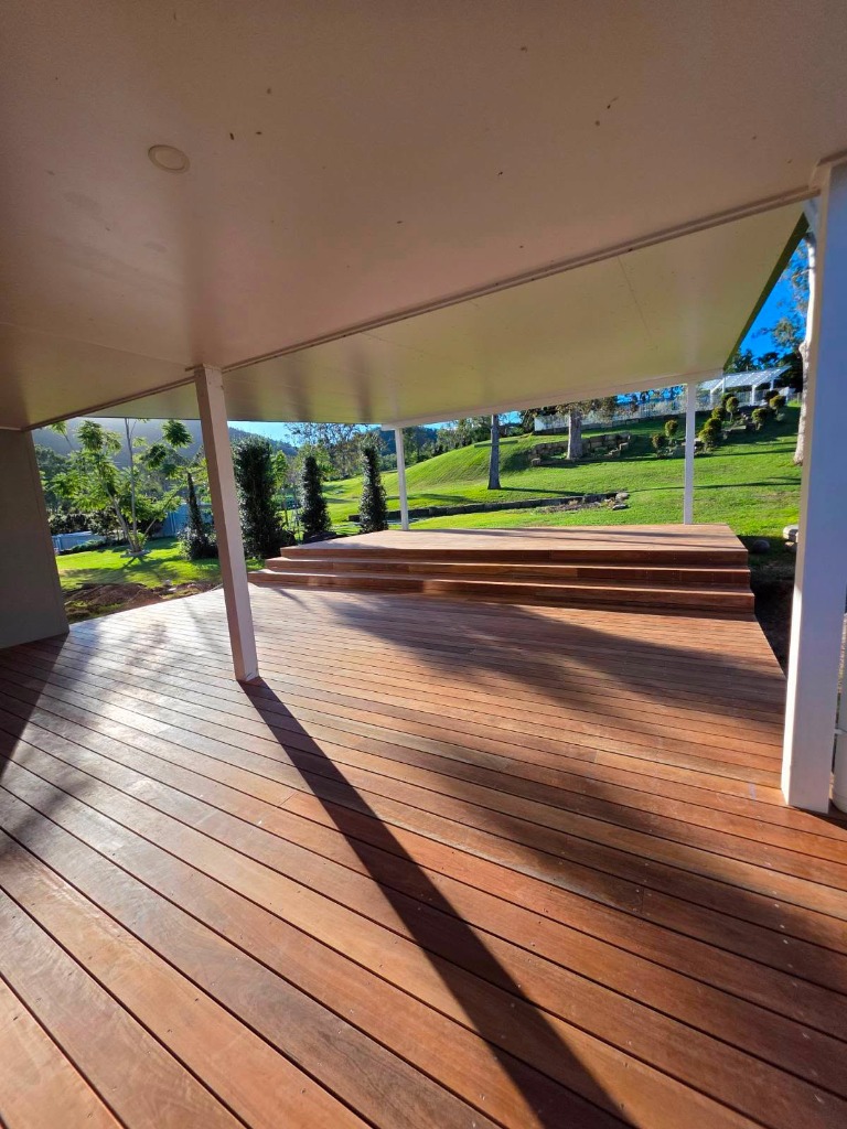 Finished custom timber deck with wide steps under outdoor roof